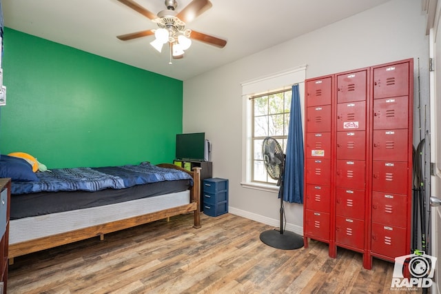 bedroom with hardwood / wood-style flooring and ceiling fan