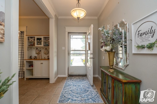 tiled foyer entrance with crown molding