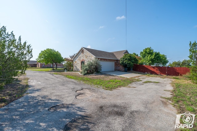 view of side of home featuring a garage