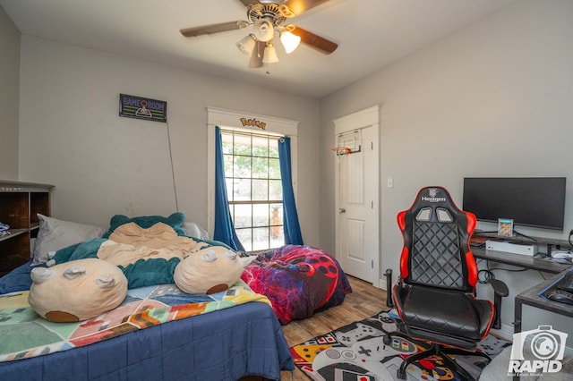 bedroom with ceiling fan and hardwood / wood-style floors