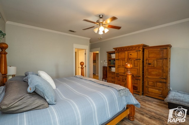 bedroom featuring hardwood / wood-style flooring, ceiling fan, and crown molding