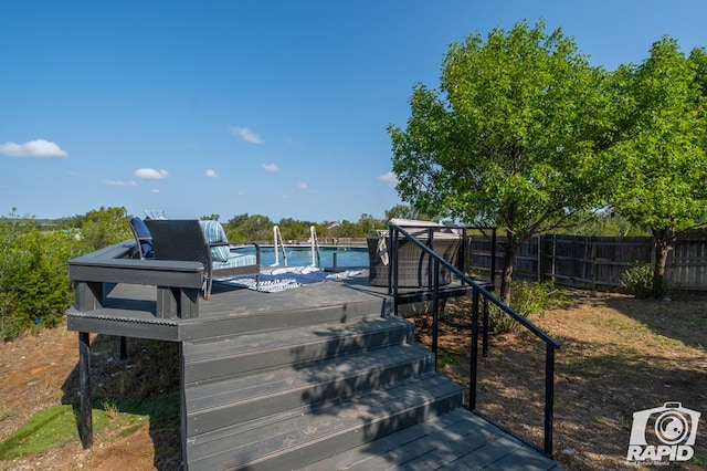 deck with a fenced in pool