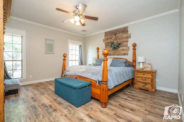 bedroom featuring crown molding, hardwood / wood-style flooring, and ceiling fan