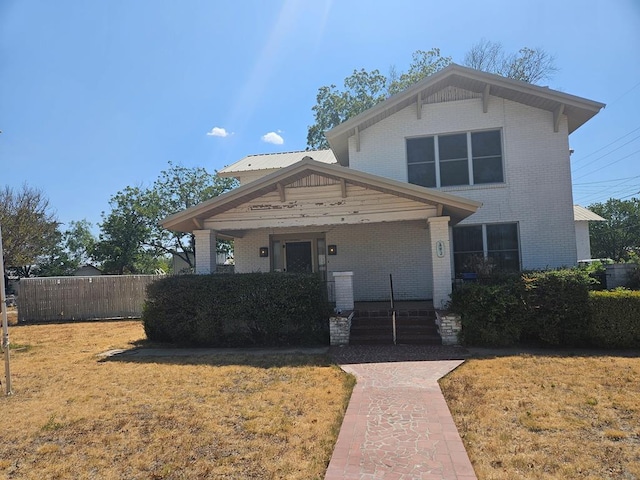 view of front of property with covered porch and a front lawn