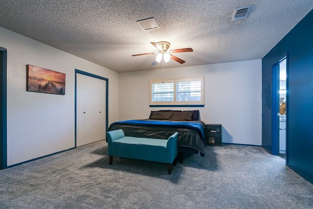 bedroom featuring ceiling fan, carpet floors, a closet, and a textured ceiling