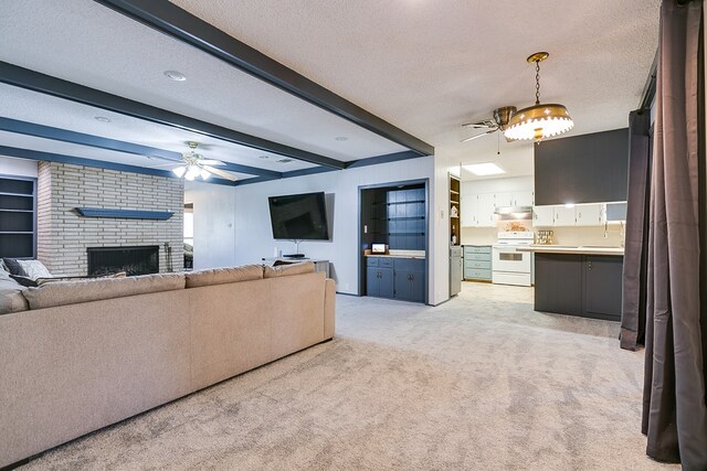 living room with a fireplace, ceiling fan, light carpet, a textured ceiling, and beam ceiling