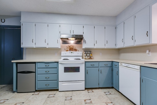 kitchen featuring backsplash, white appliances, and a textured ceiling