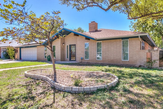 view of front of property with a garage and a front lawn