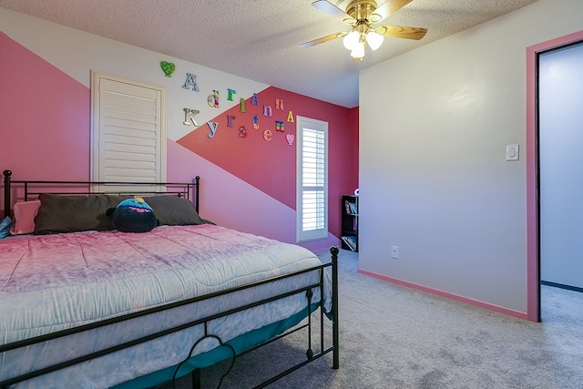 bedroom featuring ceiling fan, carpet, and a textured ceiling