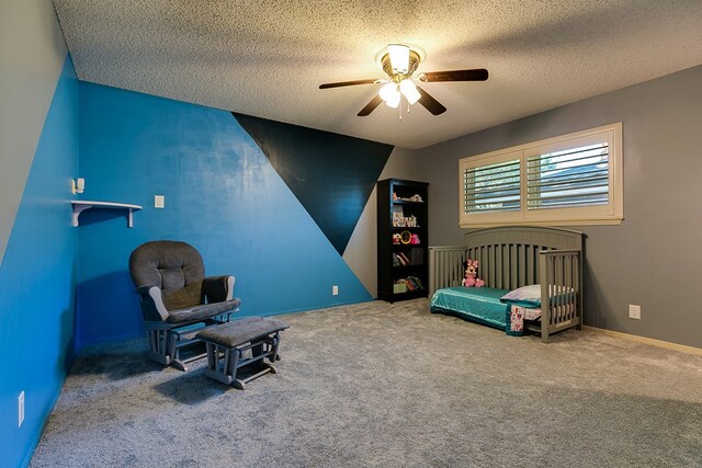 carpeted bedroom with ceiling fan and a textured ceiling