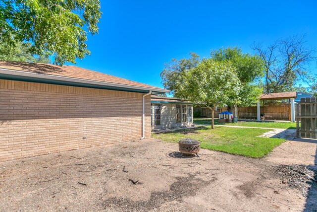 view of yard with a fire pit