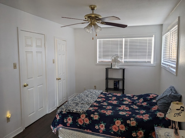 bedroom with ceiling fan and dark hardwood / wood-style floors