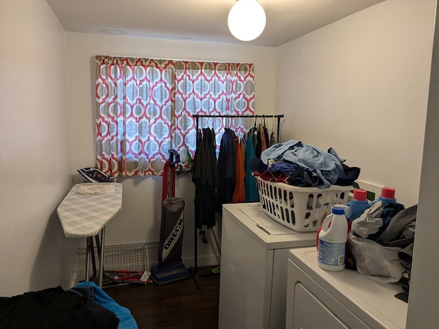 laundry room with washer and dryer and dark hardwood / wood-style floors