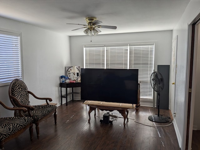 living area with ceiling fan and dark hardwood / wood-style flooring