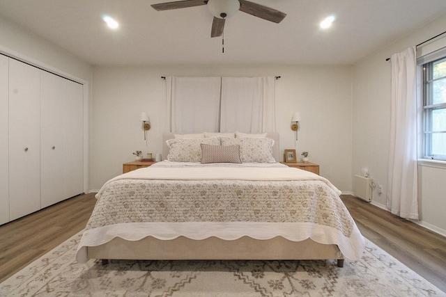 bedroom with wood-type flooring, a closet, and ceiling fan