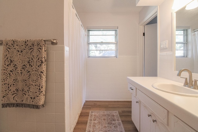 bathroom featuring tile walls, vanity, and wood-type flooring