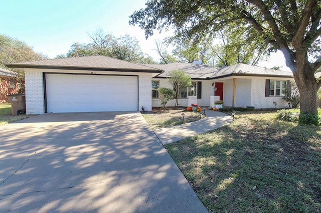 ranch-style house with a garage and a front lawn