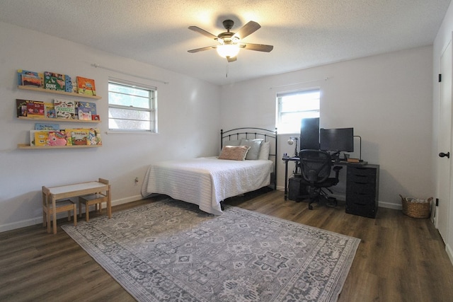 bedroom featuring ceiling fan, dark hardwood / wood-style flooring, and a textured ceiling