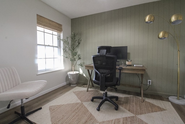 office space with hardwood / wood-style flooring and wooden walls