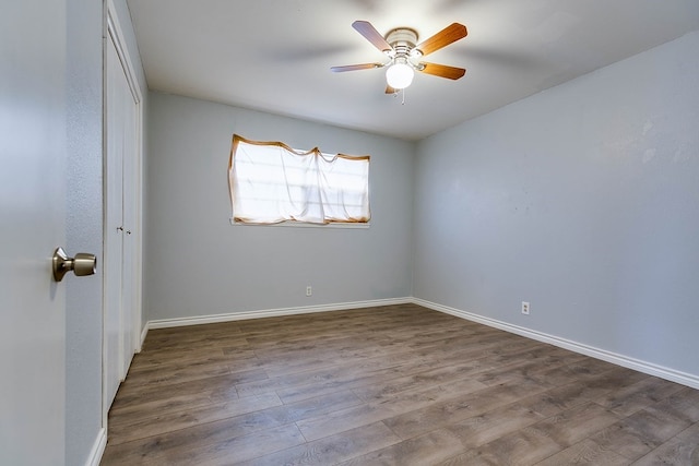 empty room with ceiling fan and wood-type flooring