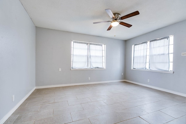 unfurnished room featuring ceiling fan and a textured ceiling