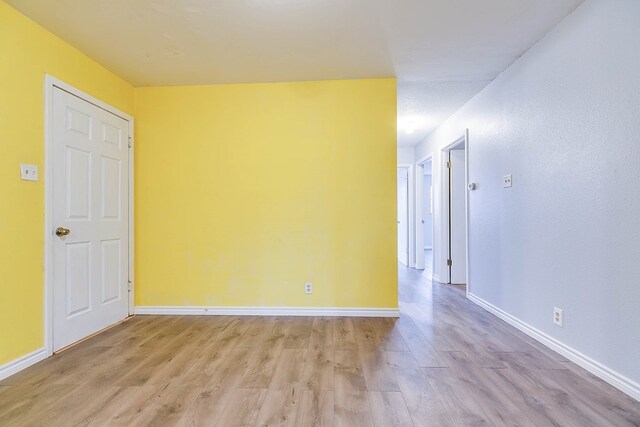 unfurnished room with light hardwood / wood-style floors