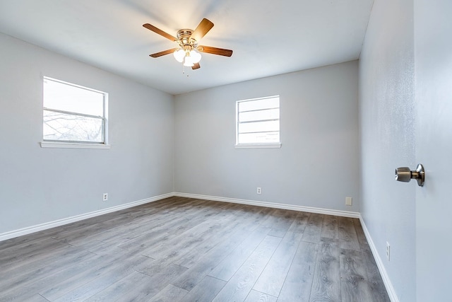 empty room with ceiling fan and light hardwood / wood-style flooring