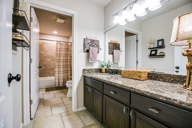 6023 Warwick Dr, San Angelo, TX 76904 - bathroom featuring vanity, shower / bath combination with curtain, and stone finish floors