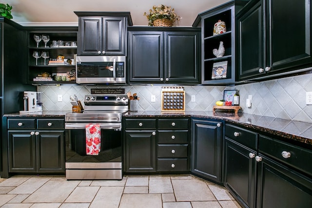 6023 Warwick Dr, San Angelo, TX 76904 - kitchen with stainless steel appliances, open shelves, decorative backsplash, dark stone counters, and dark cabinetry