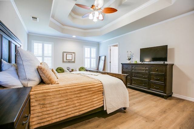 6023 Warwick Dr, San Angelo, TX 76904 - bedroom with a tray ceiling, ornamental molding, light wood-style floors, and ceiling fan
