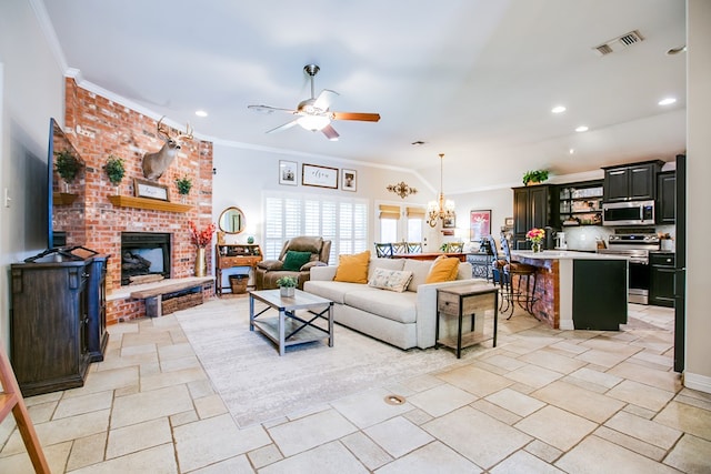 6023 Warwick Dr, San Angelo, TX 76904 - living room with a ceiling fan, crown molding, recessed lighting, a fireplace, and stone tile floors