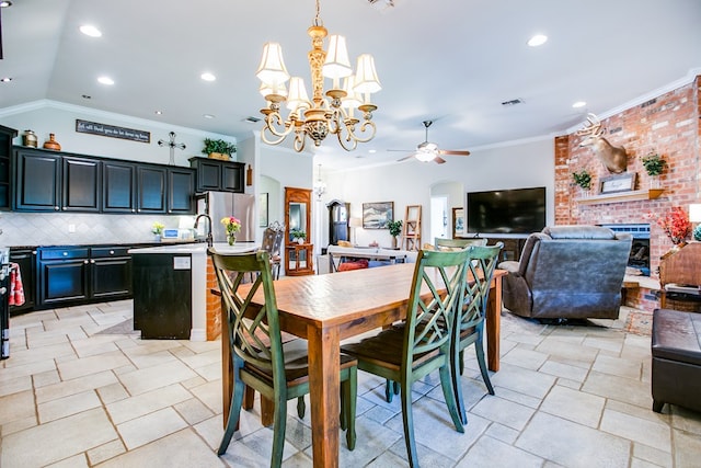 6023 Warwick Dr, San Angelo, TX 76904 - dining room featuring a chandelier, a ceiling fan, crown molding, a brick fireplace, and arched walkways