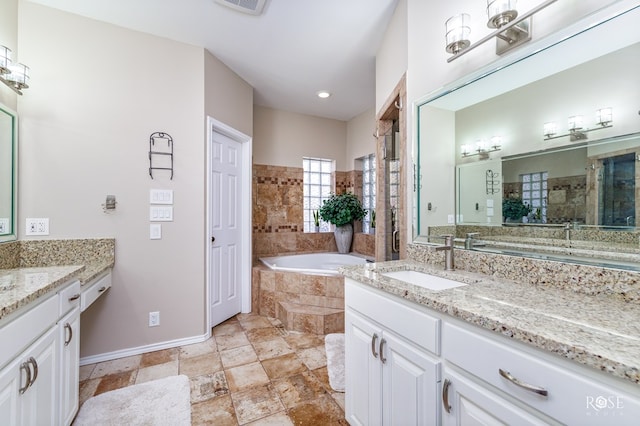 bathroom with vanity, a stall shower, visible vents, and a bath