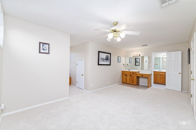 unfurnished bedroom featuring light carpet, baseboards, visible vents, and connected bathroom