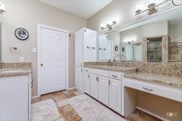 full bathroom featuring vanity, stone finish floor, and a shower stall