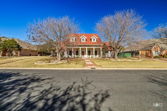 cape cod house with a front lawn and a porch