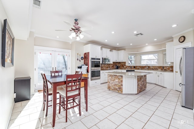 kitchen featuring visible vents, ceiling fan, appliances with stainless steel finishes, and light tile patterned floors