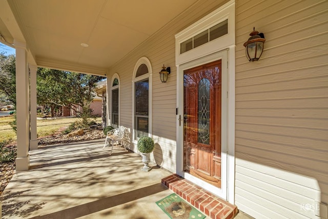view of exterior entry with covered porch