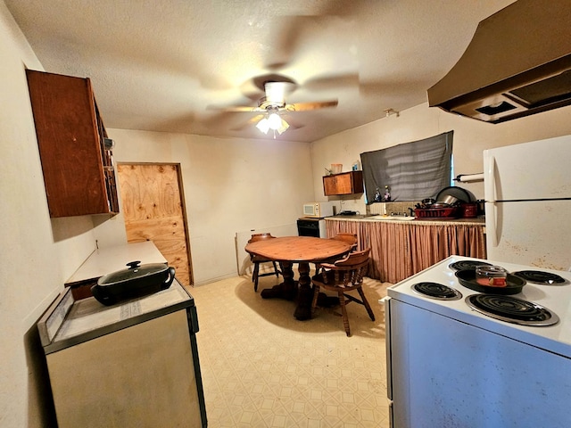 kitchen featuring ceiling fan, island range hood, and white appliances