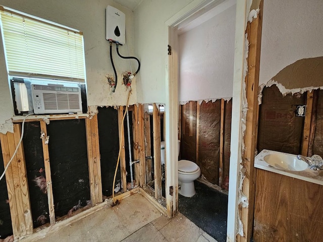 bathroom featuring vanity, cooling unit, and toilet