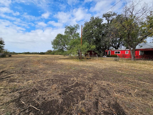 view of yard with a rural view