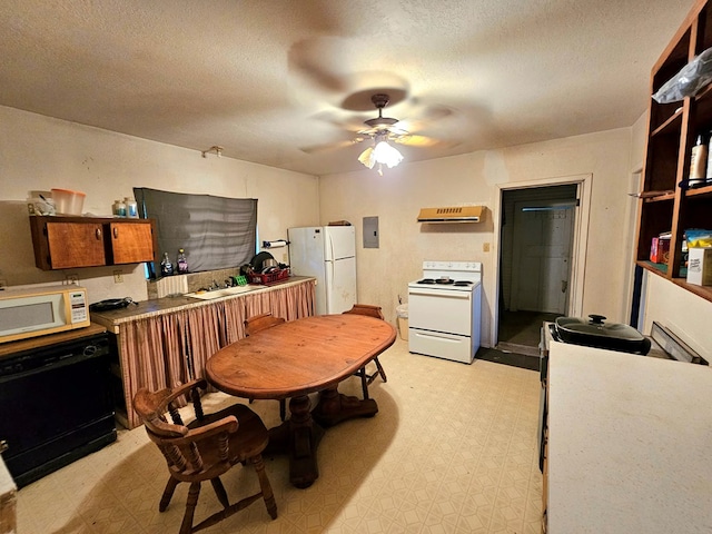 kitchen with ceiling fan, white appliances, electric panel, and a textured ceiling