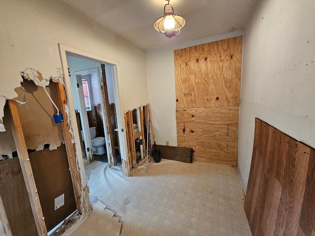 hallway with wood walls