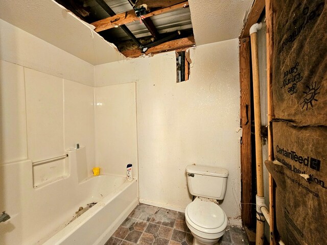 bathroom with toilet and a bathing tub