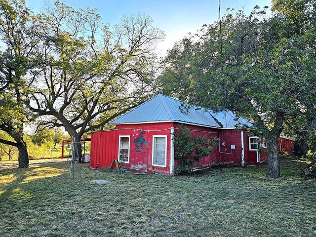 view of outbuilding featuring a yard