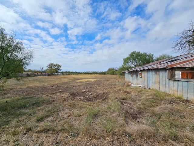 view of yard with a rural view