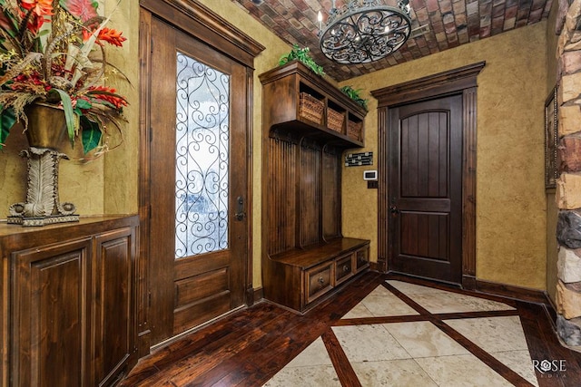 mudroom featuring hardwood / wood-style floors and brick ceiling