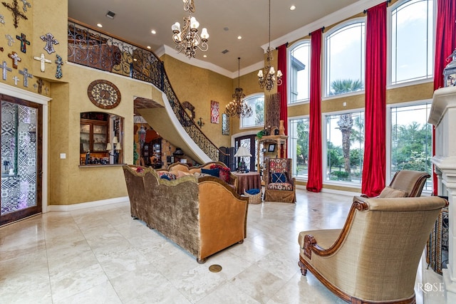 interior space featuring a high ceiling, crown molding, and an inviting chandelier