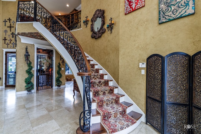 staircase featuring a high ceiling