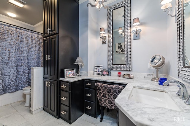 bathroom with a shower with shower curtain, ornamental molding, vanity, and toilet